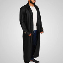 Load image into Gallery viewer, Man wearing a long black coat over a white shirt
