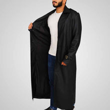 Load image into Gallery viewer, Person wearing a long black coat over a white shirt and blue jeans
