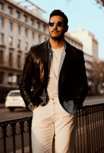 Load image into Gallery viewer, Man wearing sunglasses and a black leather jacket in an urban setting
