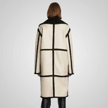 Load image into Gallery viewer, Person wearing a cream coat with black geometric patterns
